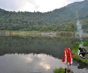 Still waters of Khechiperi Lake surrounded by green mountains